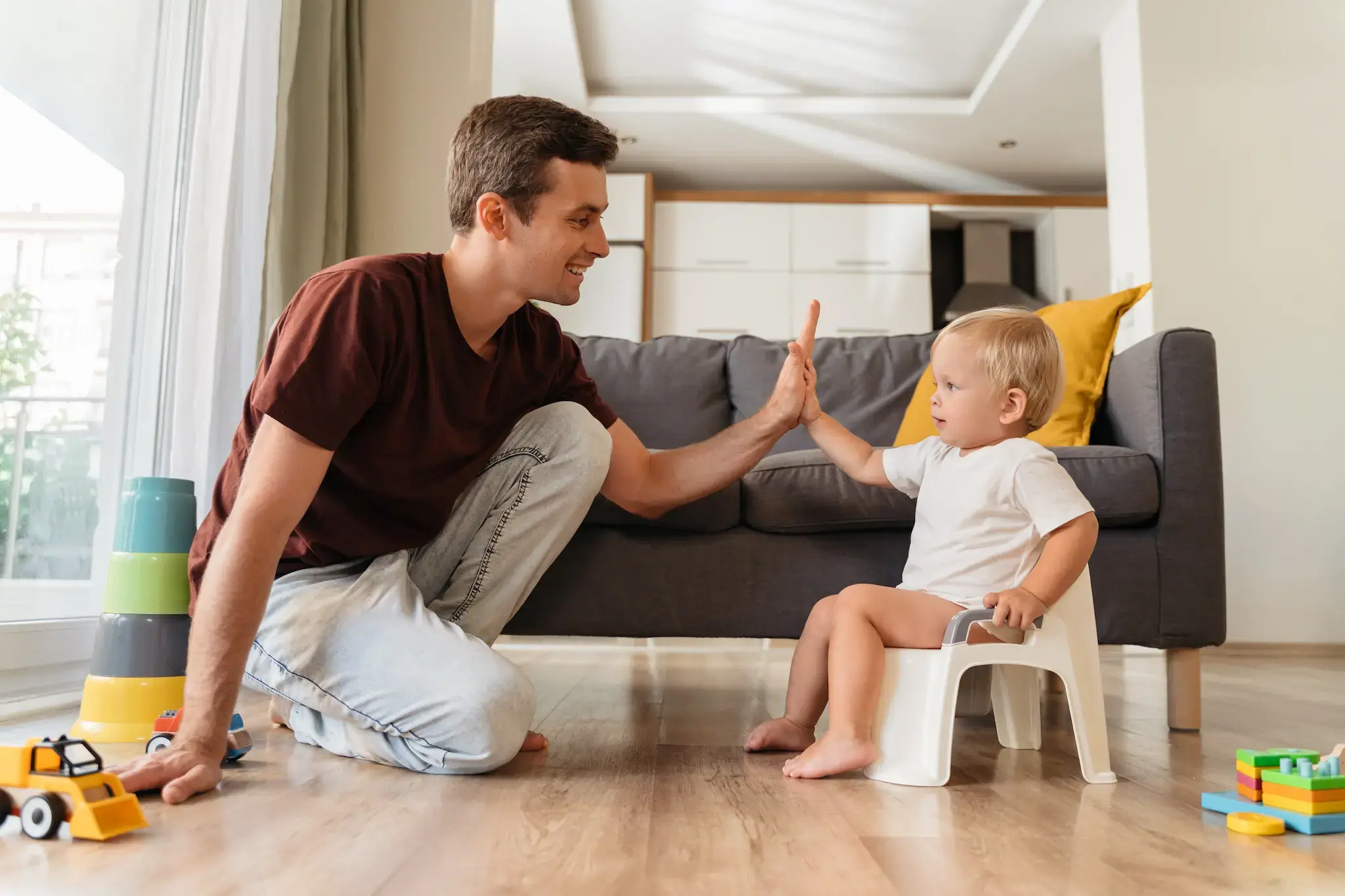Parent celebrating the successful potty training of a toddler.